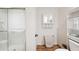 Bathroom featuring a glass door shower, mirrored medicine cabinet, and coordinating wood-look floors at 2685 Cr 776, Webster, FL 33597
