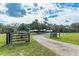 Charming property with a rustic driveway gate, spacious front yard and long home at 2685 Cr 776, Webster, FL 33597