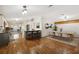 Open living space with bar seating, kitchen, dining area, and wood flooring at 2685 Cr 776, Webster, FL 33597