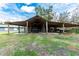 Open air barn with a gray shed and equipment at 2685 Cr 776, Webster, FL 33597