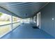 Long covered porch features painted wood and metal roof with views of the grounds at 2685 Cr 776, Webster, FL 33597