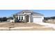 Charming single-Gathering home with stone accents, arched entryway, and a two-car garage at 2803 Supermarine Rd, Tavares, FL 32778
