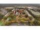 Wide aerial shot of an apartment complex featuring tennis courts, a pool, and surrounded by lush greenery at 2804 N Powers Dr # 27, Orlando, FL 32818