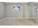 Bedroom featuring tile flooring, neutral paint, and a mirrored closet at 2804 N Powers Dr # 27, Orlando, FL 32818