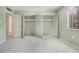 Bedroom with tiled floor, a window, and open closet space with mirrored doors at 2804 N Powers Dr # 27, Orlando, FL 32818