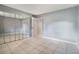 Bedroom featuring a mirrored closet, tile flooring, neutral paint, and ample natural light at 2804 N Powers Dr # 27, Orlando, FL 32818