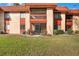 Exterior view showcases red roof tiles, patios, and well-kept landscaping for inviting curb appeal at 2804 N Powers Dr # 27, Orlando, FL 32818