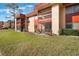 A ground-level view shows the condo's exterior, patios, and landscaping of the well-maintained community at 2804 N Powers Dr # 27, Orlando, FL 32818