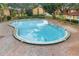 Large, inviting community pool surrounded by lush greenery offers a refreshing oasis for residents at 2804 N Powers Dr # 27, Orlando, FL 32818