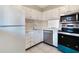 Clean white kitchen featuring stainless steel appliances, tile backsplash and modern cabinets at 2804 N Powers Dr # 27, Orlando, FL 32818