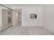 Bright living space with tile floors, natural light, and a pass-through window to the kitchen at 2804 N Powers Dr # 27, Orlando, FL 32818