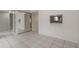 Bright living space with tile floors, natural light, and a pass-through window to the kitchen at 2804 N Powers Dr # 27, Orlando, FL 32818
