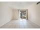 Bright living room with tile flooring and sliding glass doors to a screened lanai at 2804 N Powers Dr # 27, Orlando, FL 32818
