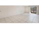 Bright living room featuring neutral walls, tile flooring and sliding glass doors at 2804 N Powers Dr # 27, Orlando, FL 32818