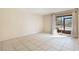 Bright living room with tile flooring and sliding glass doors leading to an outdoor space with natural light at 2804 N Powers Dr # 27, Orlando, FL 32818