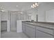 Bathroom with gray cabinetry, granite countertops, and a glass-enclosed shower at 2854 Supermarine Rd, Tavares, FL 32778