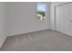 This bedroom has carpet, a large window, and a large closet at 2854 Supermarine Rd, Tavares, FL 32778