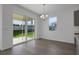 Dining area with sliding glass doors that lead to the back yard and covered patio at 2854 Supermarine Rd, Tavares, FL 32778