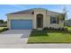 Charming single-story home with a well-manicured lawn, blue garage door and neutral paint scheme at 2854 Supermarine Rd, Tavares, FL 32778