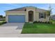 Charming single-story home with a well-manicured lawn, blue garage door and neutral paint scheme at 2854 Supermarine Rd, Tavares, FL 32778