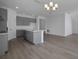 Open kitchen with gray cabinets, center island, and a view into the adjacent living space at 2854 Supermarine Rd, Tavares, FL 32778