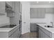 Close-up of the kitchen featuring gray cabinets, stainless steel appliances, and white countertops at 2854 Supermarine Rd, Tavares, FL 32778