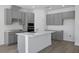 Modern kitchen featuring gray cabinets, white countertops, stainless steel appliances, and a center island at 2854 Supermarine Rd, Tavares, FL 32778
