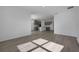 Open concept living room and kitchen with gray cabinets and hardwood floors at 2854 Supermarine Rd, Tavares, FL 32778