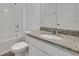 Bathroom with granite counters and white tile at 2932 Supermarine Rd, Tavares, FL 32778