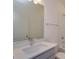 This bathroom features bright vanity lighting, a shower and a large mirror at 2932 Supermarine Rd, Tavares, FL 32778