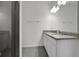 Modern bathroom features a shower with tile surround and a double vanity with granite countertop at 2932 Supermarine Rd, Tavares, FL 32778