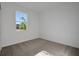Bright bedroom features neutral carpet, white walls and a window view at 2932 Supermarine Rd, Tavares, FL 32778