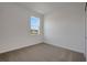 Cozy bedroom features neutral carpet, white walls and a window view at 2932 Supermarine Rd, Tavares, FL 32778