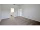 Spacious bedroom featuring carpet floors and a view of ensuite bathroom at 2932 Supermarine Rd, Tavares, FL 32778