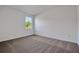 Bright bedroom features neutral carpet, white walls and a window view at 2932 Supermarine Rd, Tavares, FL 32778