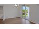 Dining room featuring wood-look floors and sliding door access to outdoor patio and backyard at 2932 Supermarine Rd, Tavares, FL 32778