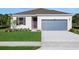 Charming single-story home with a well-manicured lawn, two-car garage and a welcoming front entrance at 2932 Supermarine Rd, Tavares, FL 32778