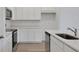 Stylish kitchen with white cabinets, stainless steel appliances, and ample counter space at 2932 Supermarine Rd, Tavares, FL 32778
