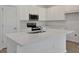Modern kitchen featuring a large island, stainless steel appliances, and white cabinetry at 2932 Supermarine Rd, Tavares, FL 32778