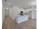 Bright kitchen features a modern island, stainless steel appliances, and white cabinets at 2932 Supermarine Rd, Tavares, FL 32778