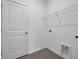 Laundry room with utility sink hookups and wire shelving at 2932 Supermarine Rd, Tavares, FL 32778