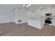Bright living room featuring wood-look floors and recessed lighting, with open kitchen and dining area at 2932 Supermarine Rd, Tavares, FL 32778