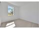 Bright bedroom featuring a neutral carpet and a large window allowing natural light to illuminate the space at 2950 Supermarine Rd, Tavares, FL 32778