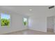 Bright bedroom with wood flooring, large windows offering natural light, and a neutral color palette at 2950 Supermarine Rd, Tavares, FL 32778