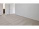 Neutral carpeted bedroom featuring an entry to an ensuite bath and two doors at 2950 Supermarine Rd, Tavares, FL 32778