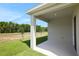 Back covered patio overlooking a spacious backyard with views of the green space at 2950 Supermarine Rd, Tavares, FL 32778