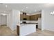 Open-concept kitchen with stainless appliances and center island in an open floor plan at 2950 Supermarine Rd, Tavares, FL 32778