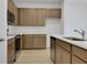 Kitchen boasts stainless steel appliances, ample counter space and light brown cabinets at 2950 Supermarine Rd, Tavares, FL 32778