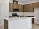 Kitchen with stainless steel appliances, light brown cabinets and center island at 2950 Supermarine Rd, Tavares, FL 32778