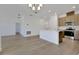Open living space featuring a kitchen, recessed lighting, and wood-look flooring at 2950 Supermarine Rd, Tavares, FL 32778